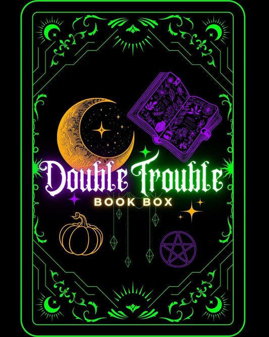Book box with 'Double Trouble' text, moon, star, pumpkin, and tarot card design on a black background.